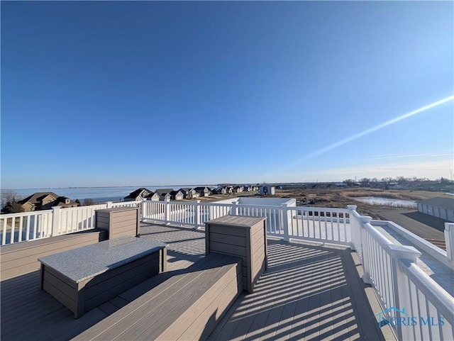 wooden deck with a water view