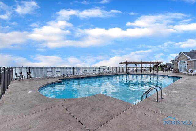 view of swimming pool featuring a pergola and a patio area