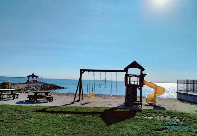 view of jungle gym with a water view and a yard