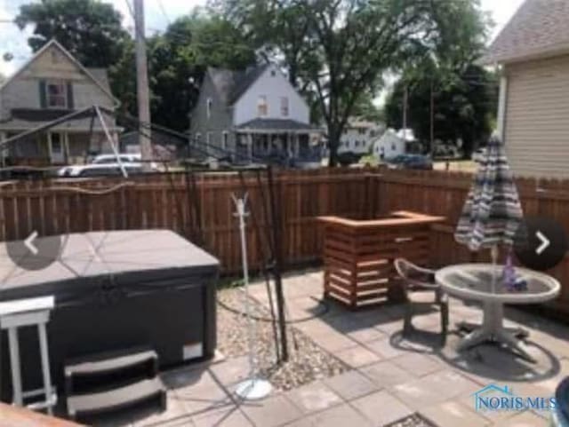 view of patio / terrace featuring a hot tub