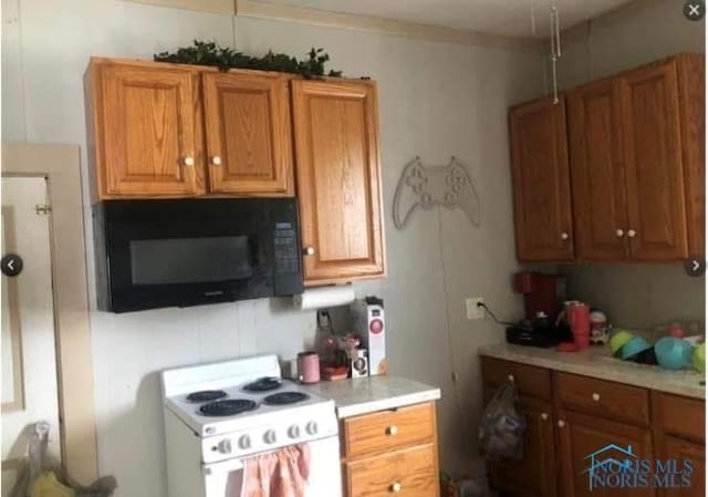 kitchen with white range with electric cooktop