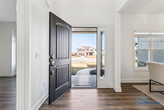 foyer with wood finished floors and baseboards