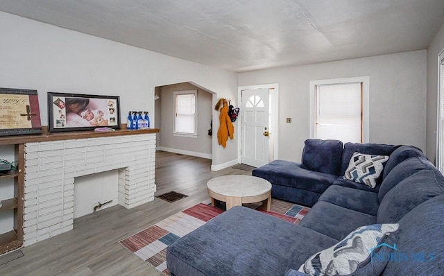 living room with a fireplace and dark hardwood / wood-style floors