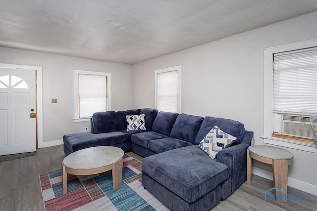 living room with cooling unit and hardwood / wood-style flooring