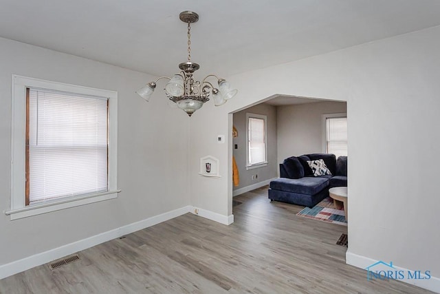 entrance foyer with an inviting chandelier and hardwood / wood-style floors