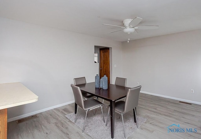 dining area featuring ceiling fan and light wood-type flooring