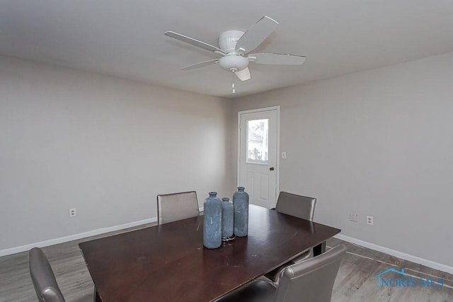 dining area featuring ceiling fan and dark hardwood / wood-style flooring