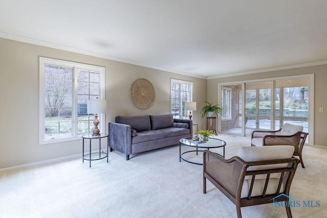 living room featuring ornamental molding, a healthy amount of sunlight, and light carpet