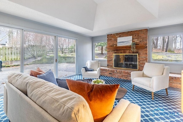 carpeted living room with lofted ceiling and a brick fireplace