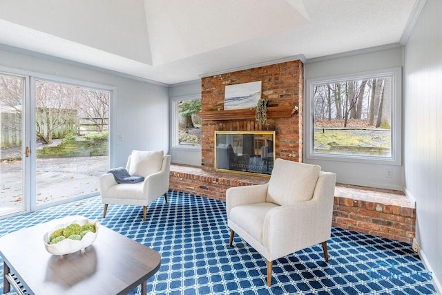 living area featuring ornamental molding, a brick fireplace, carpet flooring, and a wealth of natural light