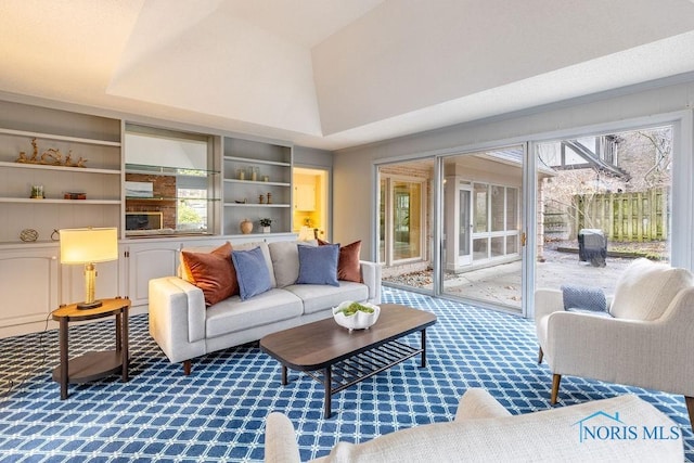 carpeted living room featuring built in features