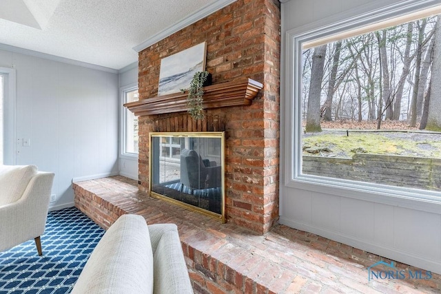 living room with crown molding, a fireplace, and a textured ceiling