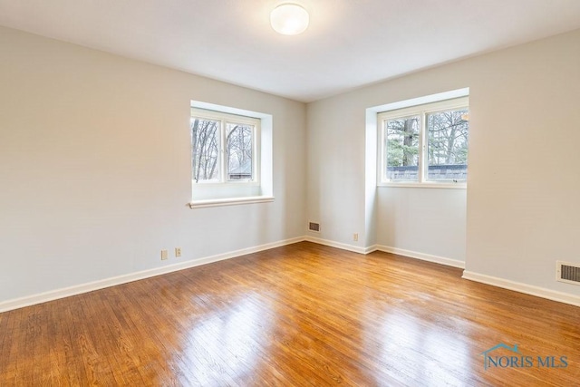 unfurnished room featuring light hardwood / wood-style flooring