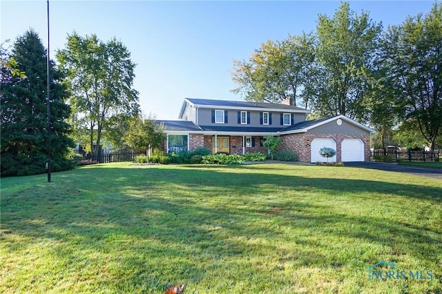 view of property with a garage and a front yard