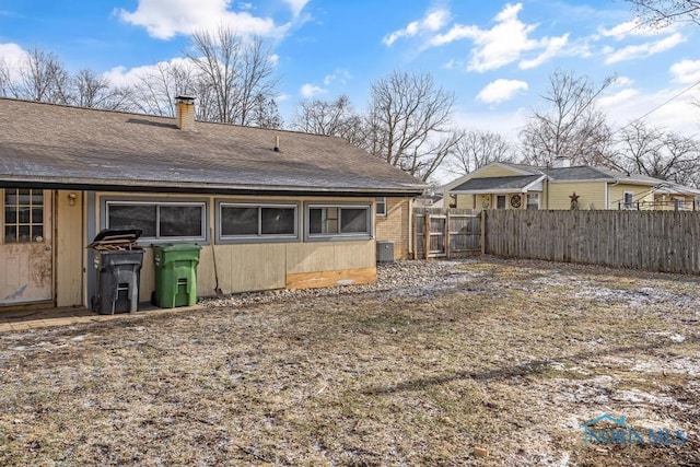 back of property featuring central AC