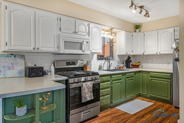 kitchen with white cabinetry, backsplash, stainless steel appliances, and dark hardwood / wood-style floors