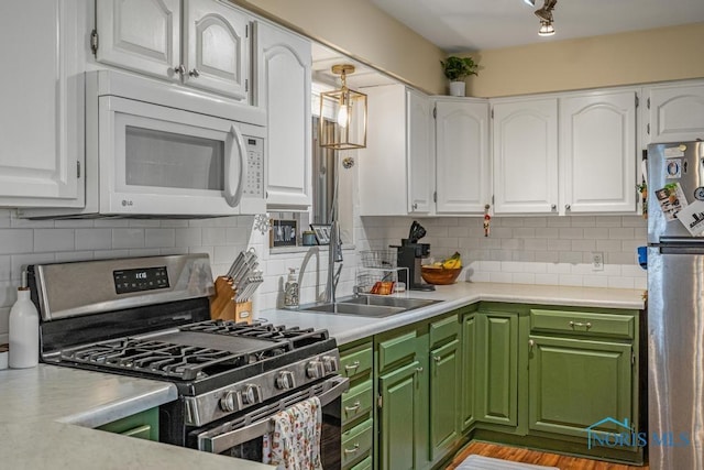 kitchen with white cabinetry, sink, backsplash, and stainless steel appliances