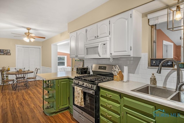 kitchen featuring dark hardwood / wood-style floors, sink, white cabinets, green cabinetry, and stainless steel gas range oven