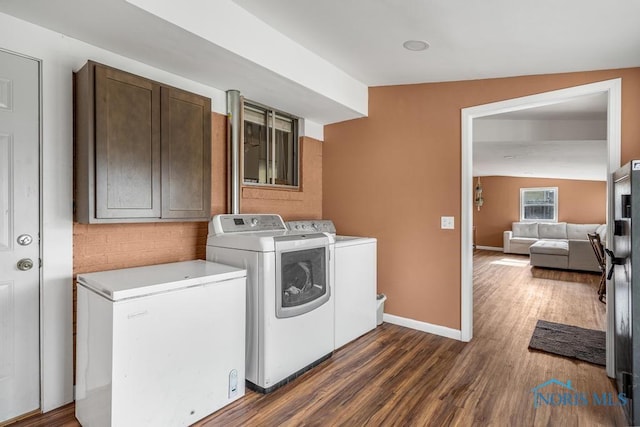 washroom featuring dark hardwood / wood-style flooring and washer and clothes dryer