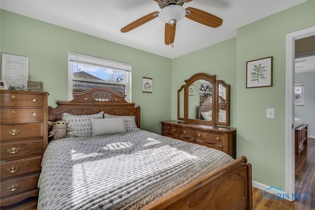 bedroom with dark hardwood / wood-style floors and ceiling fan