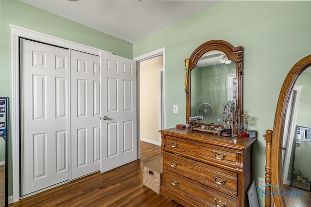 bedroom featuring dark hardwood / wood-style flooring and a closet