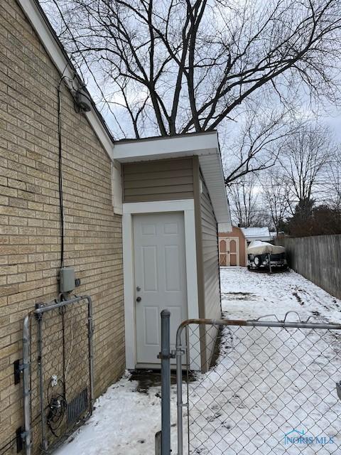 view of snow covered property entrance