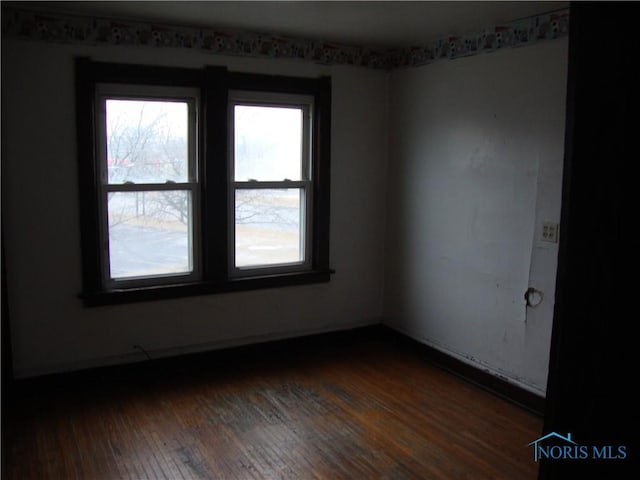 unfurnished room featuring dark hardwood / wood-style floors