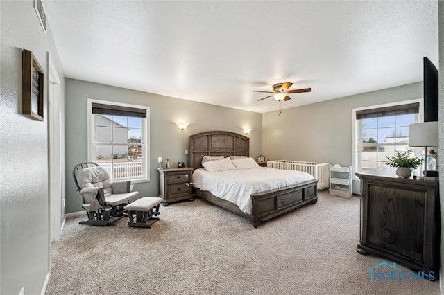 bedroom featuring light colored carpet and ceiling fan