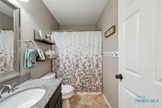 bathroom with vanity, tile patterned floors, and toilet