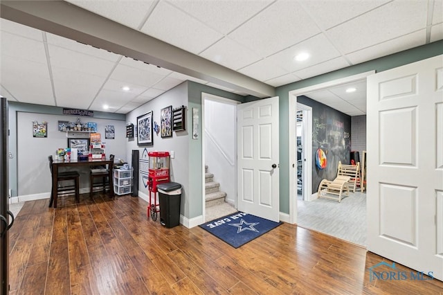 entrance foyer featuring dark hardwood / wood-style flooring and a paneled ceiling