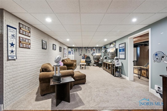 living room featuring a paneled ceiling and carpet