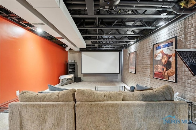 home theater featuring brick wall