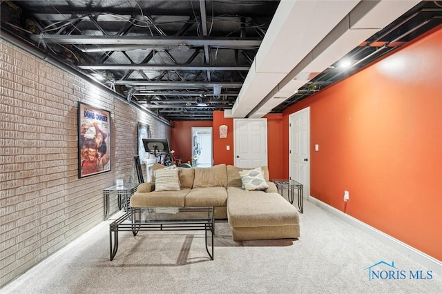 living room featuring brick wall and carpet