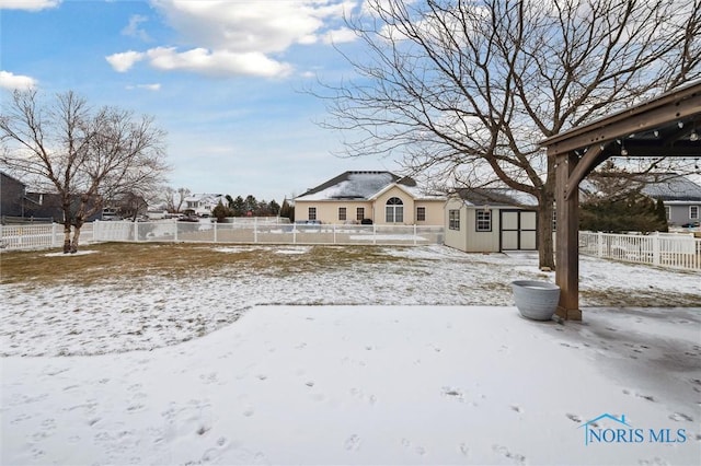 snowy yard with a shed