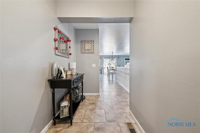 hallway featuring light tile patterned floors