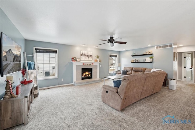 living room with ceiling fan and light colored carpet