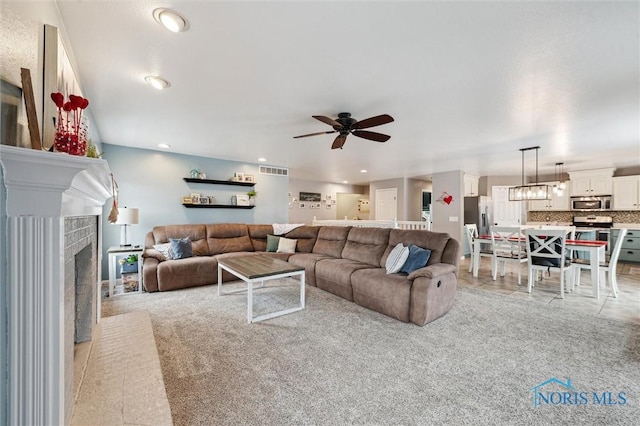 living room with light carpet and ceiling fan