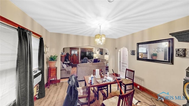 dining room with a notable chandelier and light hardwood / wood-style floors