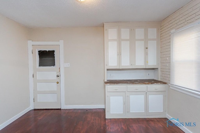 kitchen featuring white cabinetry, dark hardwood / wood-style floors, and a wealth of natural light