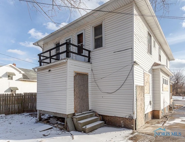 snow covered house with a balcony