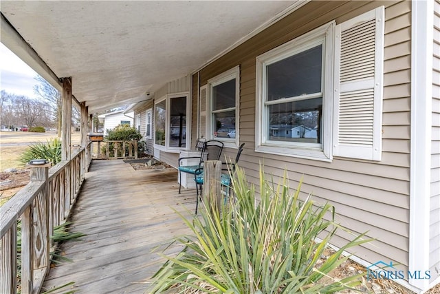 wooden terrace featuring covered porch