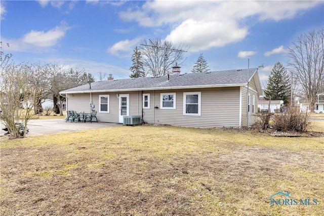 rear view of house with a yard, central AC, and a patio