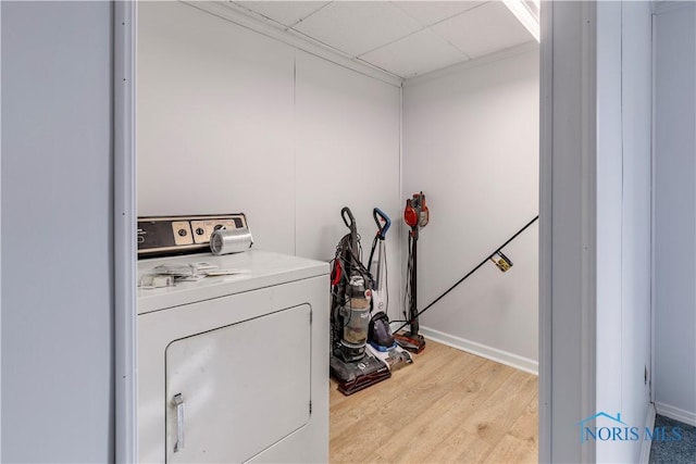 washroom featuring washer / dryer, laundry area, light wood-style flooring, and baseboards