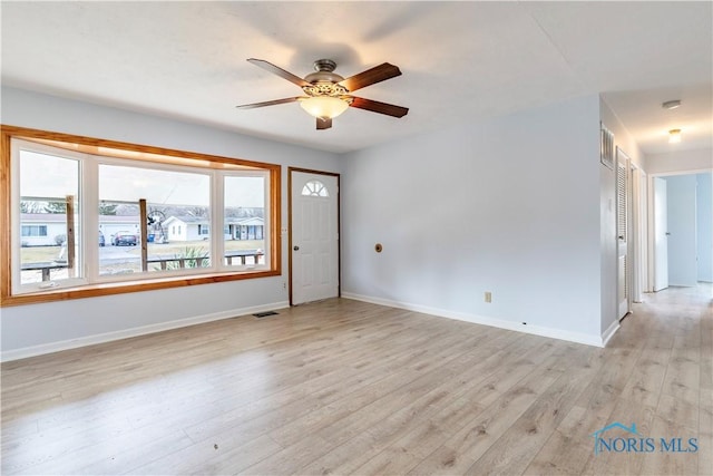 unfurnished room featuring light wood-type flooring, baseboards, and a ceiling fan