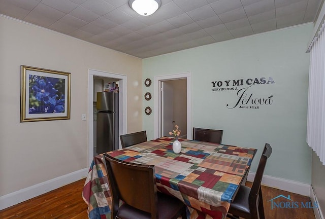 dining area featuring dark wood-type flooring