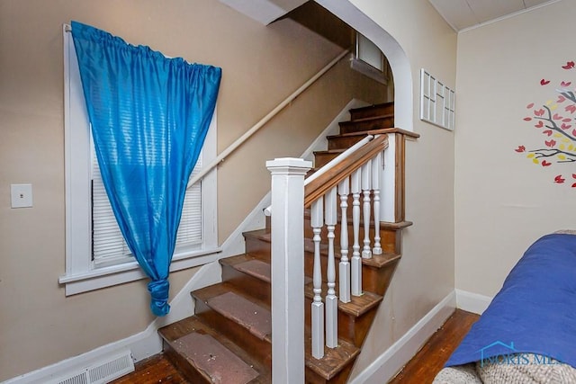 stairway with hardwood / wood-style flooring