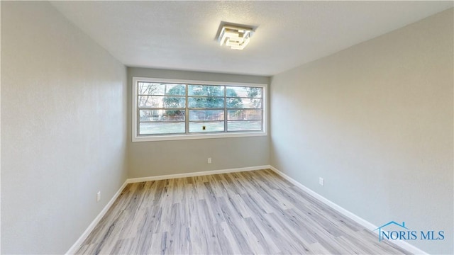 spare room featuring light hardwood / wood-style flooring