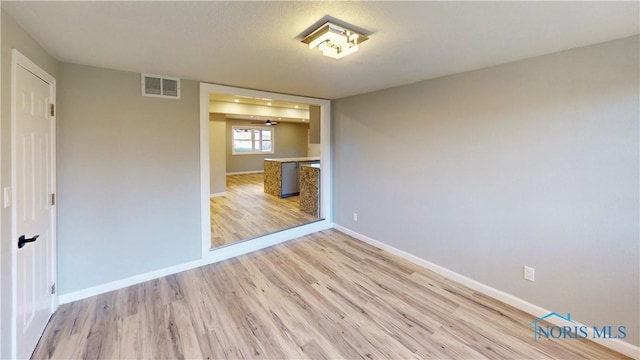 unfurnished room with light wood-type flooring