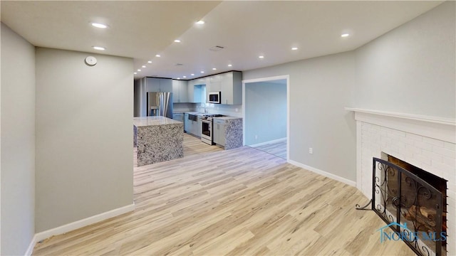 living room featuring a fireplace and light hardwood / wood-style floors