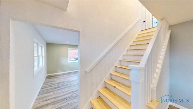 stairs featuring hardwood / wood-style flooring